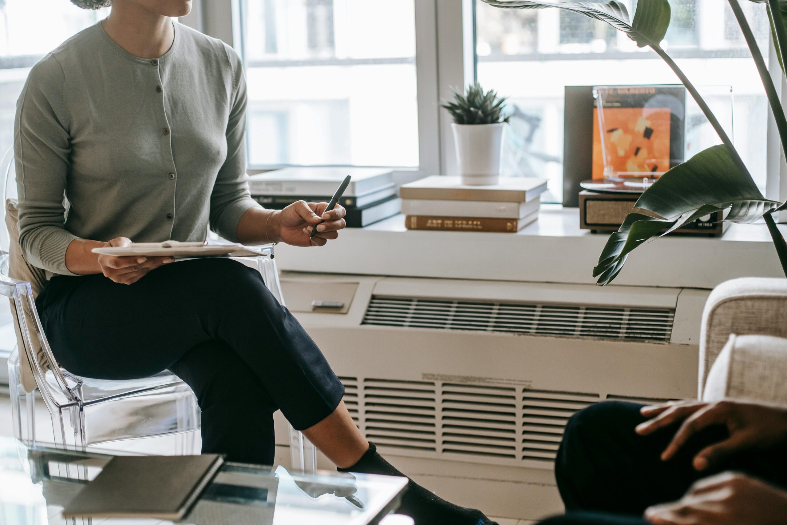 Psychologist consulting a patient in a modern office, emphasizing confidentiality and care.