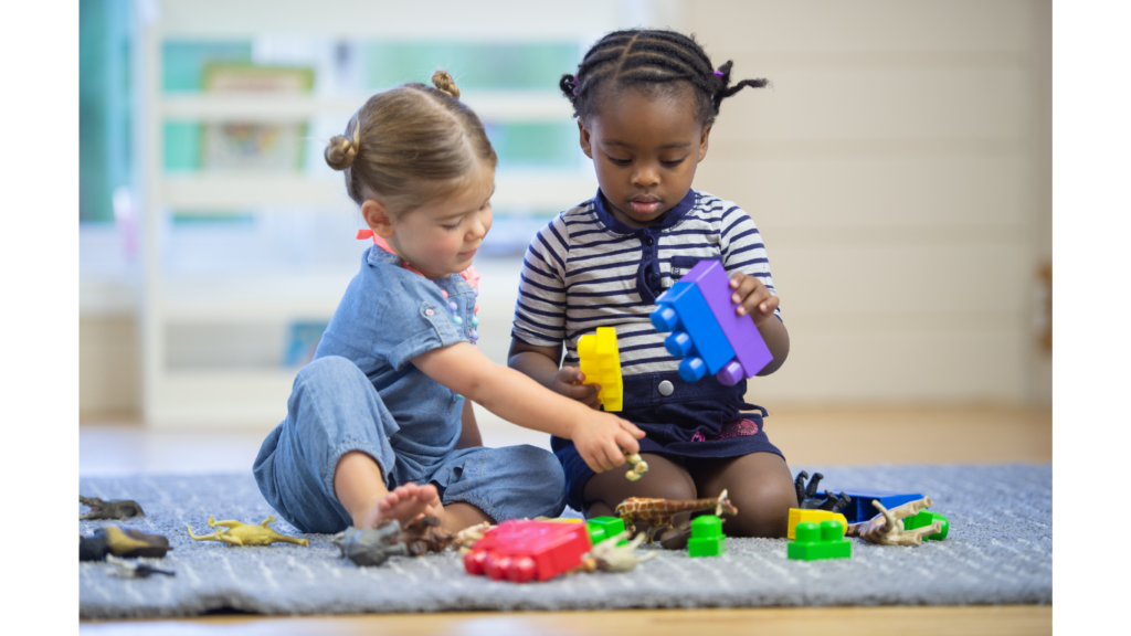 Picture of two children playing with block legos 