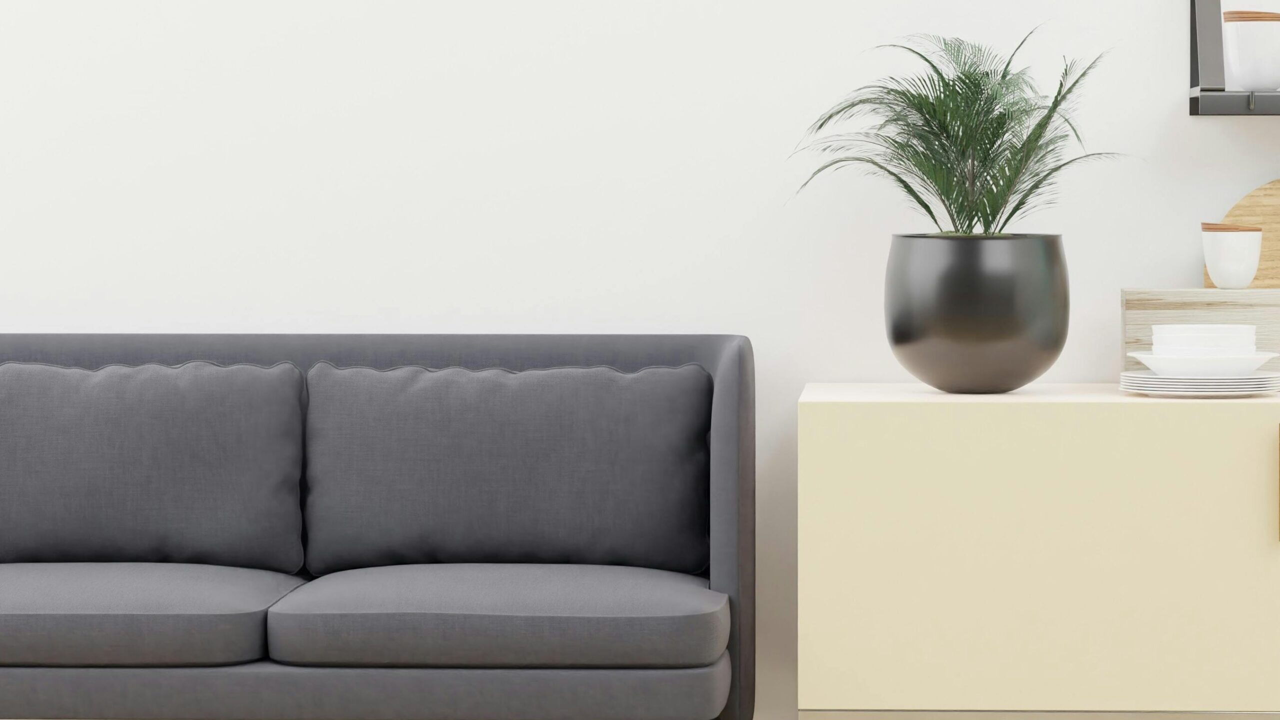 Bright and stylish minimalist living space with modern kitchen decor and cozy sofa.