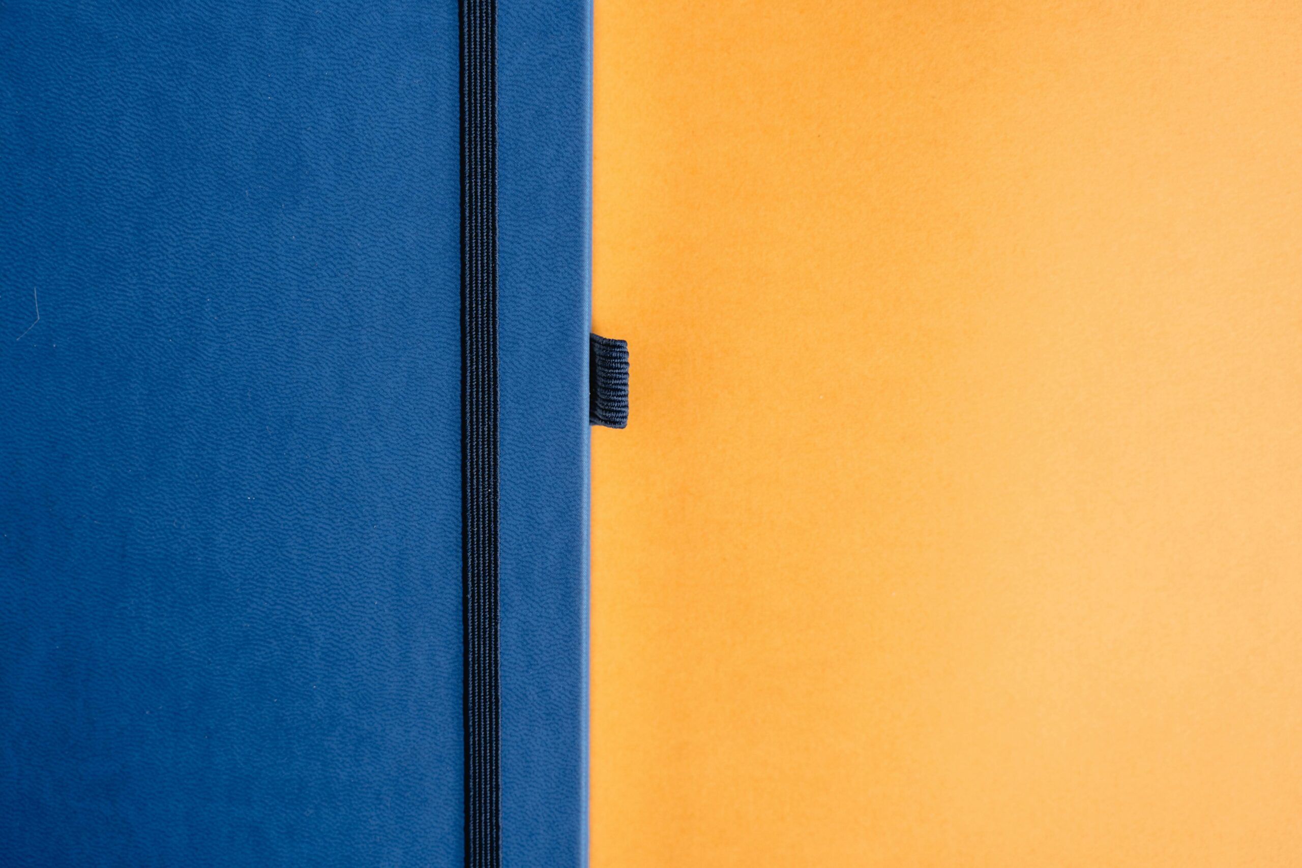 pexels-photo-1672322-1672322 A minimalist design featuring a blue notebook against a bright yellow backdrop.